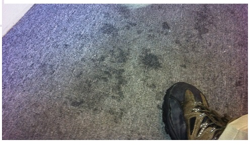 CALCIUM CHLORIDE ICE MELT RESIDUE ATTRACTS MOISTURE, AND CAUSES CARPET TO BOTH REMAIN WET AND LEAVE DARK MARKS THAT DO NOT LOOK LIKE SALT RESIDUE