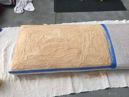 Evenly apply absorbent powder to the stained areas, and adjacent areas of the fabric as well-