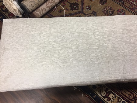 The wine stain has been completely removed from the fabric, with no texture distortion, water stains, or color loss